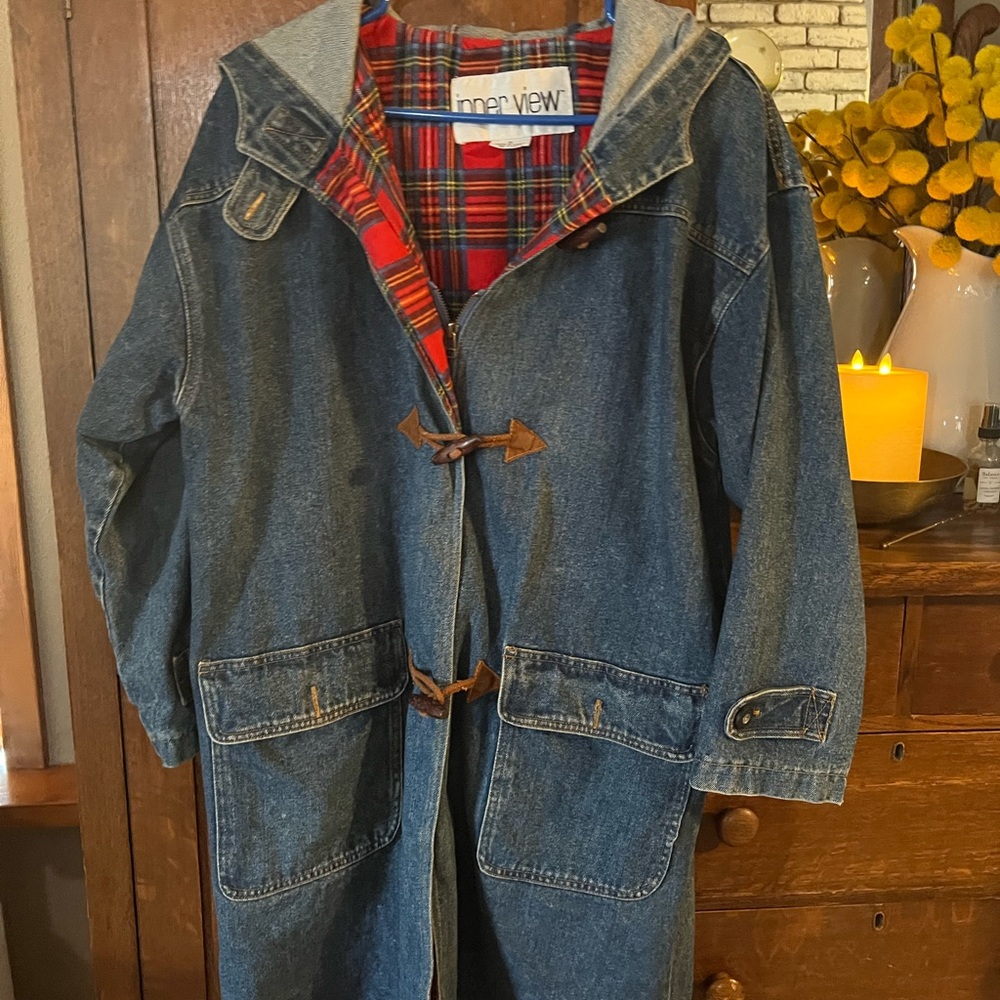 Hooded women’s Jean jacket with plaid inner lining.